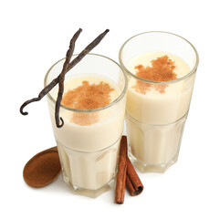 Delicious protein shake in glasses, cinnamon and vanilla pods isolated on white