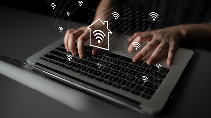 A person types on a laptop surrounded by wireless internet symbols, representing the seamless...