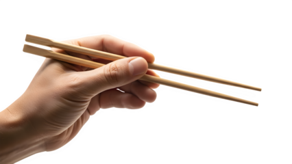 Close up of a person's hand expertly holding natural bamboo chopsticks ready to pick up food against a