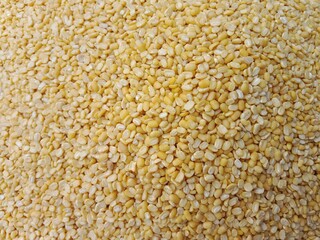 yellow lentils pile displayed in order on vendor's.split yellow mung beans pile show for sale in the market.split yellow mung dal pattern background
