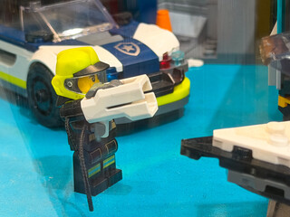 Naklejka premium Lego police figure with weapon and car