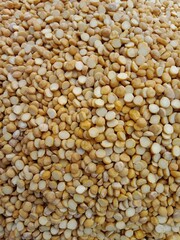 yellow lentils pile displayed in order on vendor's.split yellow mung beans pile show for sale in the market.split yellow mung dal pattern background.
