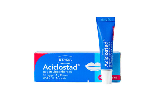 Aciclostad aciclovir cream with box and tube isolated on white. Clean studio product image for pharmacy and skincare use.