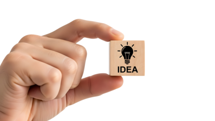 Hand holding a small wooden block featuring a lightbulb icon and the word “IDEA,” symbolizing creativity, innovation, brainstorming, and business inspiration.