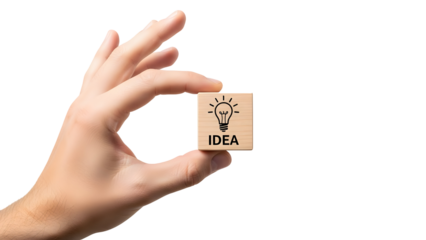 Hand holding a small wooden block featuring a lightbulb icon and the word “IDEA,” symbolizing creativity, innovation, brainstorming, and business inspiration.