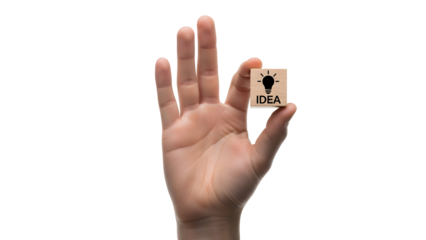 Hand holding a small wooden block featuring a lightbulb icon and the word “IDEA,” symbolizing creativity, innovation, brainstorming, and business inspiration.