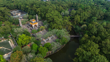 Aerial view of the Tomb of Tu Duc, an imperial tomb from the Nguyen Dynasty in Hue, Vietnam, surrounded by forest, lakes, and traditional Vietnamese architecture.