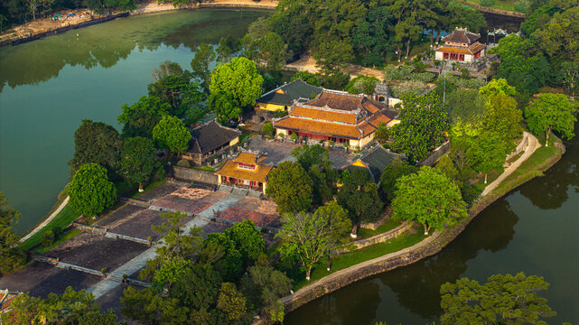 Aerial view of the Tomb of Tu Duc, an imperial tomb from the Nguyen Dynasty in Hue, Vietnam, surrounded by forest, lakes, and traditional Vietnamese architecture.