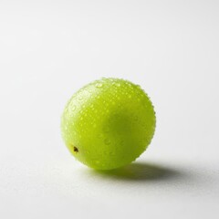 Single vibrant green grape covered in refreshing water droplets on white