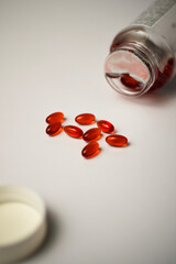 Potrait of red pills spilling out from a dropped medicine container. Perfect for health promotion.