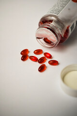 Potrait of red pills spilling out from a dropped medicine container. Healthcare and medical concept