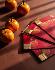 Red envelopes with mandarin oranges prosperity concept