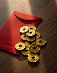 Red envelope with ancient Chinese coins prosperity concept