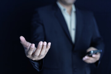 Elegant close-up of a businessman holding his hand out with an open palm, symbolizing trust,...