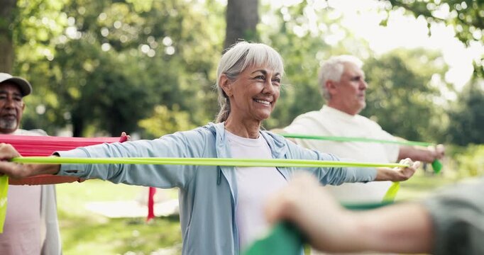 Fitness class, old woman and exercise in park with resistance band, happiness or stretching arms. Group, active elderly person and smile outdoor with elastic for workout, mobility or muscle strength.