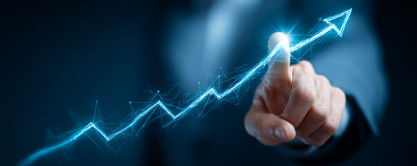 Hand pointing to a glowing blue upward trending graph symbolizing growth