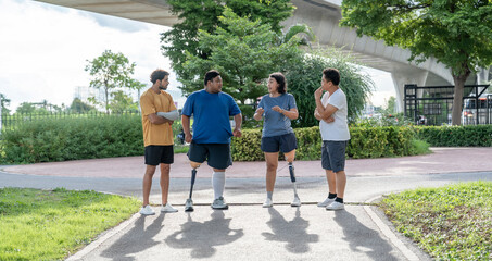 group of diverse people in sportswear exercise in the city park,person with prosthetic leg enjoying walking and talking with friends while workout in the evening sun