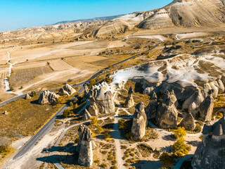 Cappadocia (Kapadokya)’s sunset landscape, captured in a panoramic drone view, highlights the region’s fairy-tale texture and its natural rock formations in a striking way.