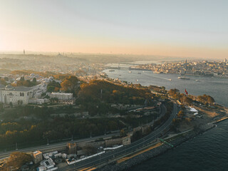 Istanbul illuminated by sunset reveals a dynamic view where bridges, crowds and traffic blend beautifully in an aerial composition.