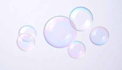 Colorful soap bubbles floating on white background