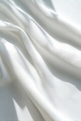 Fototapeta premium Soft white fabric with flowing texture and gentle shadows