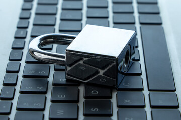 Padlock on a laptop keyboard. Digital security, data protection, and online safety concept.