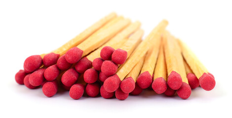 Pile of wooden safety matches with red heads isolated on white