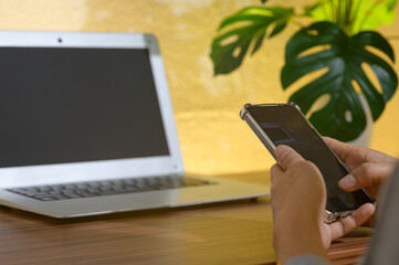 Modern Workspace with Laptop and Smartphone on Wooden Desk