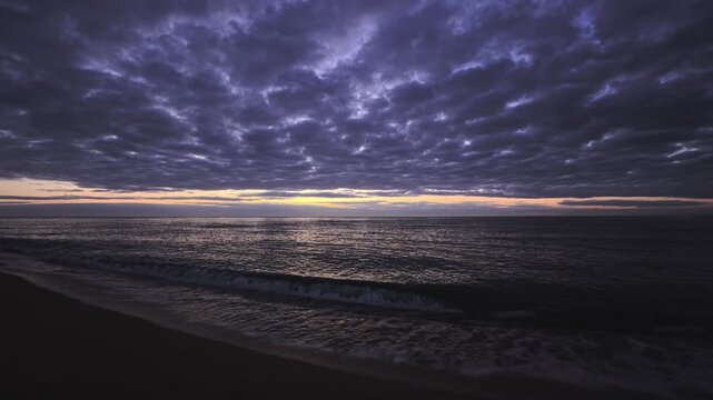 Patterned Cloud Layer Above Rolling Sea at Dawn in Arenys Coast