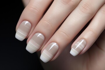 Woman's hand displaying an elegant beige and white striped nail art manicure