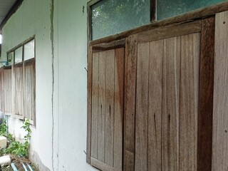 Old Wooden House Window With Weathered Texture and Aging Wall