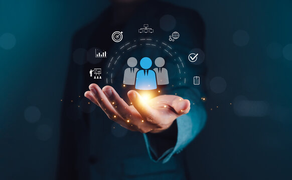 Customer Relationship Management concept showing a businessperson using digital technology to manage and analyze customer data for marketing and sales strategy in modern business.