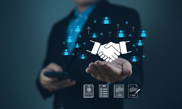 touch partner affiliate marketing global business collaboration-concept Businessman presenting digital handshake concept with networking icons in a professional setting.