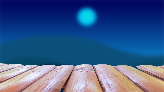 A wooden table with a blurred background of the sky and moon at night.
