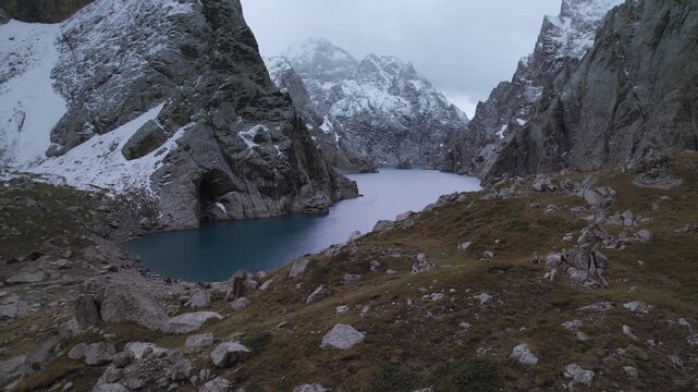 Aerial rising drone shot revealing Kel-Suu Lake in the remote mountains of Naryn, Kyrgyzstan