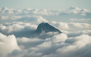 Mountain peak rising above thick white clouds aerial view, moody atmospheric nature landscape background, soft misty summit skyline, for travel, hiking, adventure, wallpaper, banner.