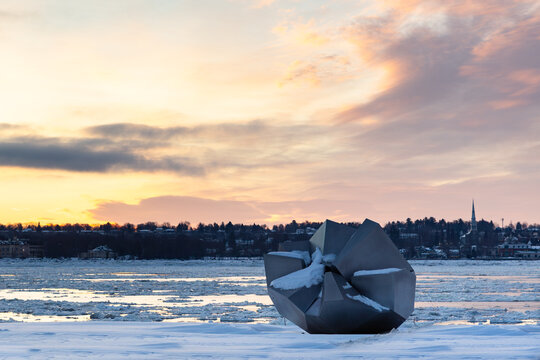 Quebec City, Quebec, Canada, December 13, 2025 - Convergence, a sculpture by Jean-Pierre Morin seen on the Champlain Boulevard linear park during a winter sunrise over the St. Lawrence river