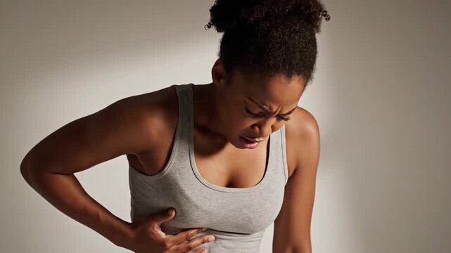 Woman Experiencing Intense Abdominal Pain Due to Stomach Discomfort or Digestive Issue in a