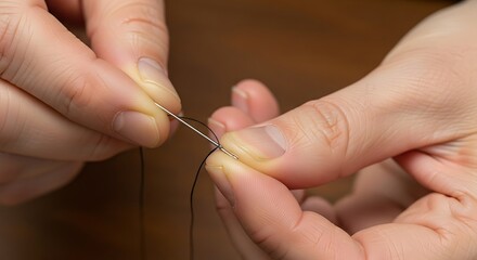Close-up image showcasing a person threading a needle with fine thread