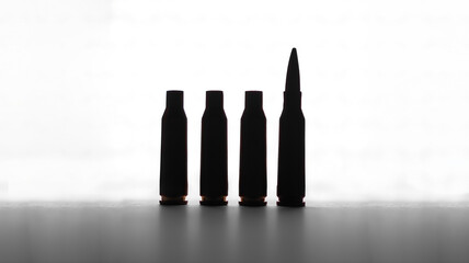 Silhouettes of cartridge casings and a bullet on a white background, security and military concept
