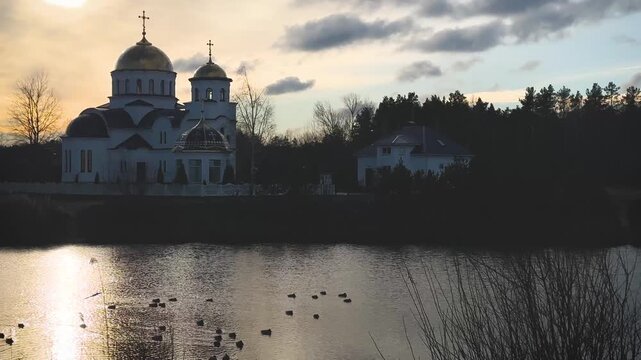 Orthodox church and lake at sunrise