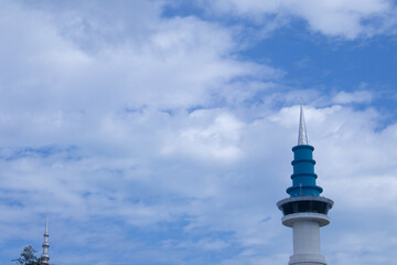 The minaret of Sultan Mahmud Riayat Syah Mosque in Batam with a blue sky background