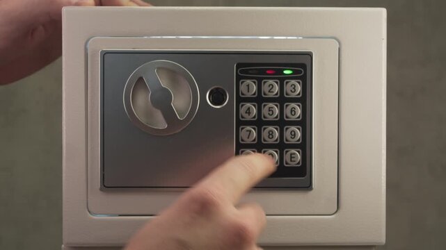 Close up shot shows person placing memory card with compromising photos or confidential data inside safe, then firmly closing door and locking it with code to keep information hidden.