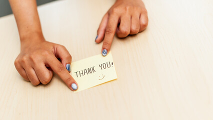Gratitude gesture home office thank you note indoor setting close-up view appreciation concept