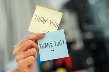 Gratitude expression hand holding thank you notes office setting close-up positive vibes