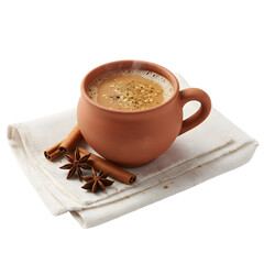 Clay Cup Filled With Hot Chai Tea And Cinnamon Sticks On White Napkin