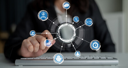 A business professional engages with a digital interface while using a keyboard, showcasing various software icons in a modern workspace, highlighting innovation and productivity. Crux