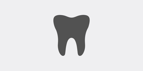 A simple dark gray silhouette of a single human molar tooth on a white background