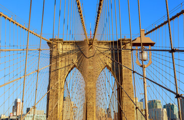 Fototapeta premium View from Brooklyn Bridge showing cables stone structure under clear blue sky