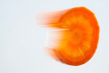 Close up of a vibrant orange carrot slice with radial blur effect.